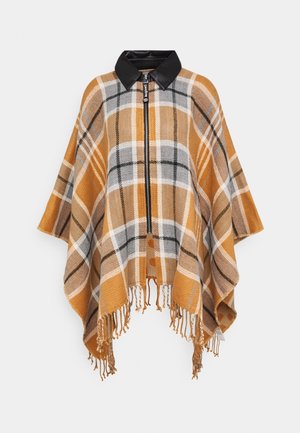 Geruit poncho met mosterdgele, grijze en witte ruitjes, zwarte leren kraag, rits aan de voorkant en franjes aan de zoom, hangend tegen een witte achtergrond.