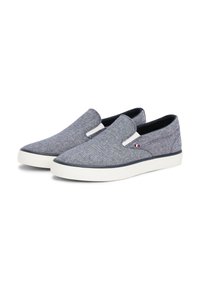 Sivi tkaninski slip-on cipele s glatkom teksturom, bijelom gumenom potplatom i mornarskoplavim detaljima. Imaju elastične bočne panele za lakše obuvanje.