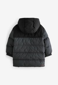 Black puffer jacket with a hood, featuring a two-tone design, quilted texture, elastic cuffs, and a subtle logo detail near the hem.
