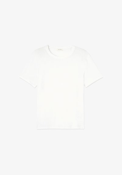 T-shirt en coton blanc avec un col rond, des manches courtes et une coupe décontractée. Texture lisse et design minimaliste, sans motifs ni accents.