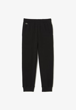Pantalon de survêtement noir à taille élastique avec poignets côtelés et petit logo crocodile vert sur la hanche gauche.