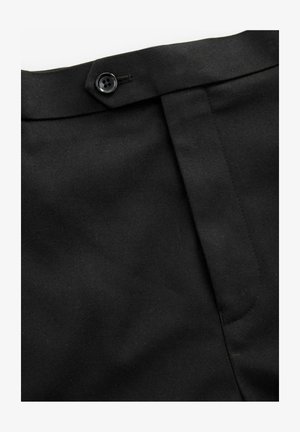 Pantaloni neri su misura con fronte piatto, chiusura con bottone e tessuto testurizzato. Presentano una vita liscia e cuciture laterali discrete.