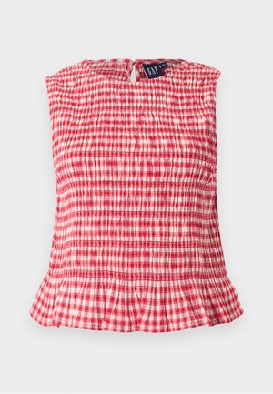 Punase-valge ruuduline varrukateta top, millel on kroogitud kangas, volangidega alumine serv ja tagaküljel võtmekujuline nööp.