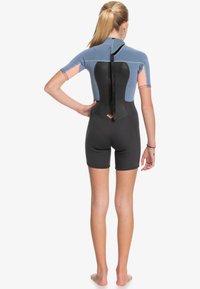 Short-sleeve wetsuit in blue and black with pink accents. Features a full-back zipper and a fitted design with short legs. Made of stretchy material.