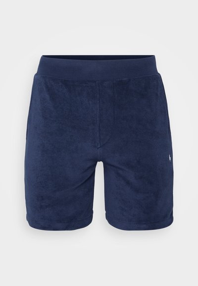 Marineblå terry-stoff shorts med en glatt tekstur, elastisk midjebånd og en subtil logoaksent på venstre side.