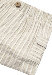 Pantalones cortos de tela beige claro con rayas blancas verticales, que cuentan con una cintura elástica, un botón de madera y un bolsillo lateral.