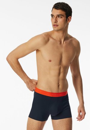 Men's boxer shorts in dark navy fabric with a smooth texture and an orange elastic waistband featuring the brand name "SCHIESSER".