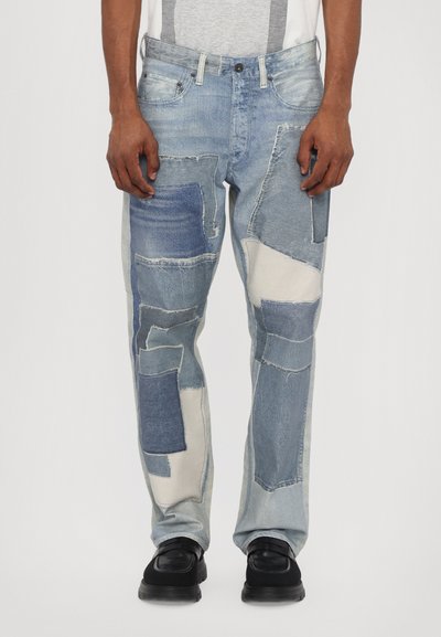 Light blue patchwork jeans with various denim textures and shades, featuring a relaxed fit and standard five-pocket design.