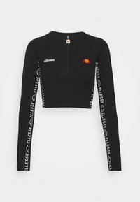 Svart kortärmad långärmad topp med dragkedja vid halsen, med vit logotekst längs ärmarna och en färgaccent på bröstet.