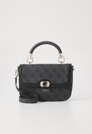 Black Guess handbag with patterned surface, gold "G" clasp, wrapped top handle, and detachable shoulder strap on a white background.