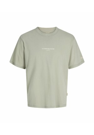 Lichtgroen T-shirt met korte mouwen met de tekst "LA CORNICHE D’AZURE" op de borst en handtekening op de linkermouw, ronde hals.