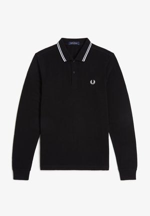 Polo de manga larga negro con doble raya blanca en el cuello y un pequeño logo blanco de corona de laurel en el pecho izquierdo.