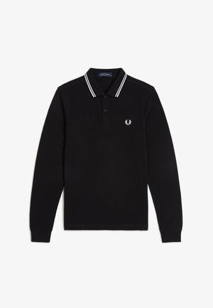 Polo de manga larga negro con doble raya blanca en el cuello y un pequeño logo blanco de corona de laurel en el pecho izquierdo.