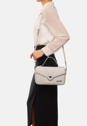 Borsa a mano in pelle grigio testurizzata con manico superiore, tracolla staccabile, chiusura circolare in metallo e dettaglio del marchio sul davanti.
