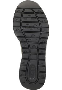 Semelle de chaussure en caoutchouc noir avec des motifs de semelle profonds, y compris des formes en zigzag et hexagonales. Détail de logo visible sur la zone du talon.