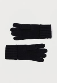 Svart strikkede hansker har en ribbestrikket mansjett, med en glatt tekstur og en fingerløse design på høyre hanske for bruk med berøringsskjerm.