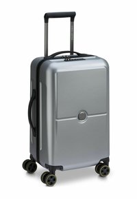 Silver hard-shell suitcase with a rectangular design, featuring a retractable handle, black wheels with yellow accents, and a textured surface.
