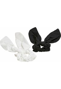Två tyg-håraccessoarer: en i vitt med långa, slappa öron och en scrunchie-bas, den andra i svart med liknande designfunktioner.