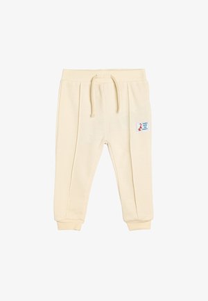 Cremefarvede bomulds-sweatpants med ribbet tekstur, snøre i taljen, tapered manchetter og en sidelap med et rævdesign.