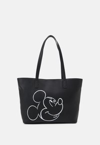 Musta olkalaukku, joka on valmistettu synteettisestä nahasta. Laukussa on valkoinen piirros sarjakuvahahmon päästä toisella puolella ja kaksi yhteensopivaa kahvaa.