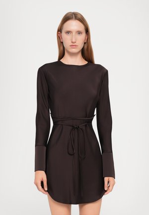 Black long-sleeve dress in smooth fabric with a waist tie and rounded hem, featuring a simple crew neckline and cuffed sleeves.