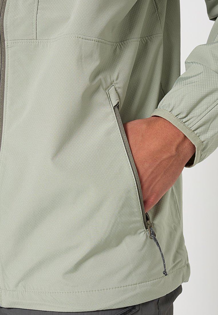 Hellgrüne, mit Reißverschluss ausgestattete Jacke mit strukturiertem Material und elastischen Bündchen. Verfügt über eine seitliche Tasche mit Zuglasche und einen geraden Saum.