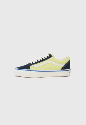 Blue and yellow canvas sneakers with white laces, a white side stripe, and a slim white sole featuring a blue accent on the bottom.