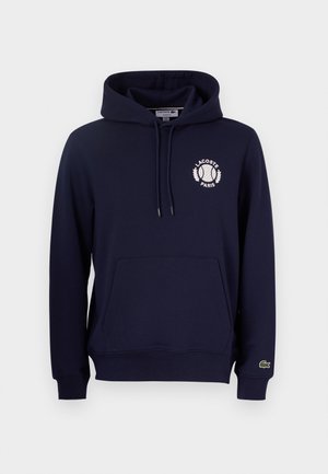 Navy blue hoodie made of cotton blend, featuring a front kangaroo pocket, drawstring hood, and a white Lacoste logo with a tennis motif.