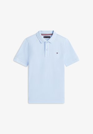 Light blue short-sleeve polo shirt with two buttons, collar, and small Tommy Hilfiger logo on the left chest.