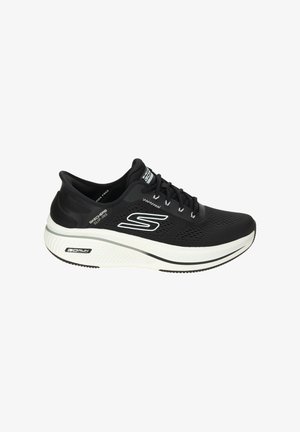 Black and white Skechers running shoe with thick sole, lace-up front, breathable mesh upper, and "S" logo on side.