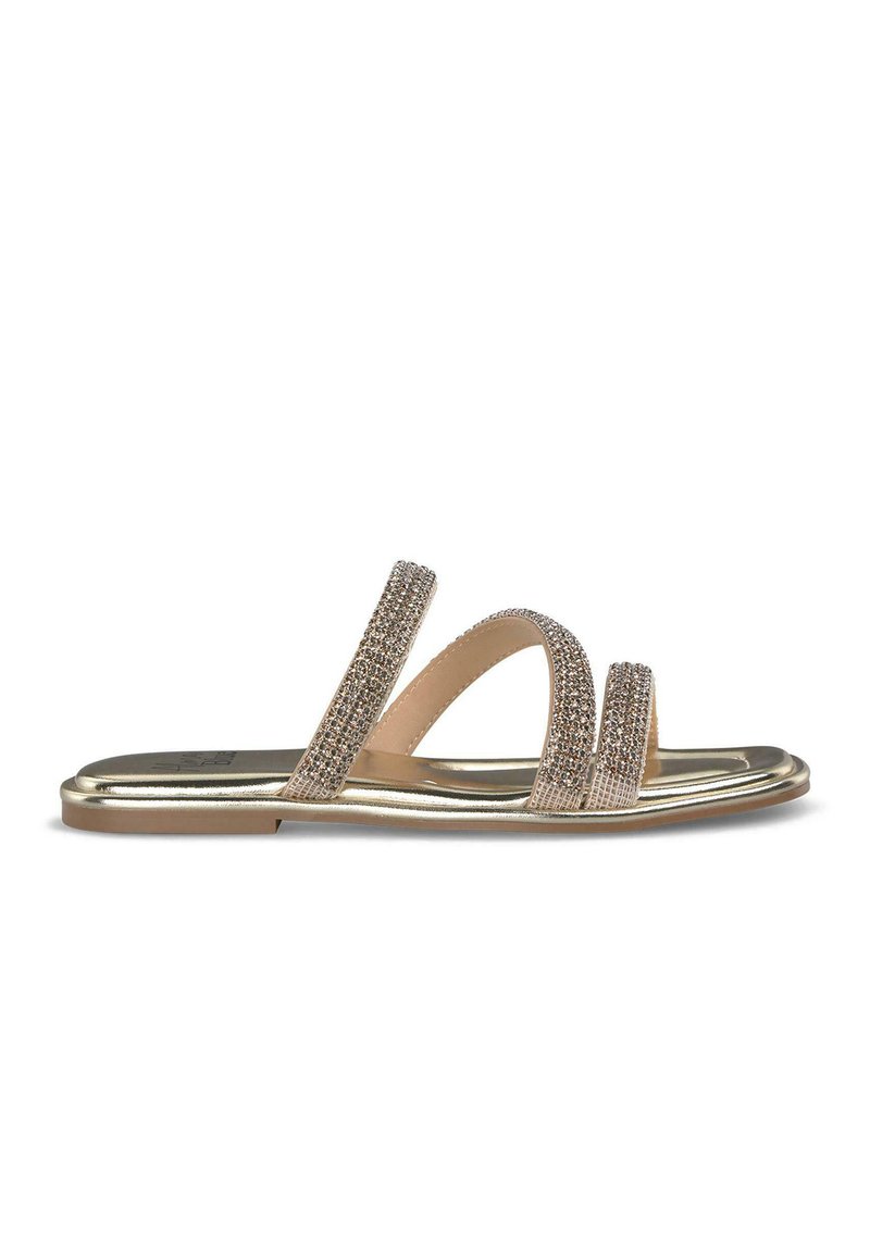 Gold-toned sandal with three embellished straps, featuring a flat sole and a shiny finish. Upper has rhinestone detailing for added texture.