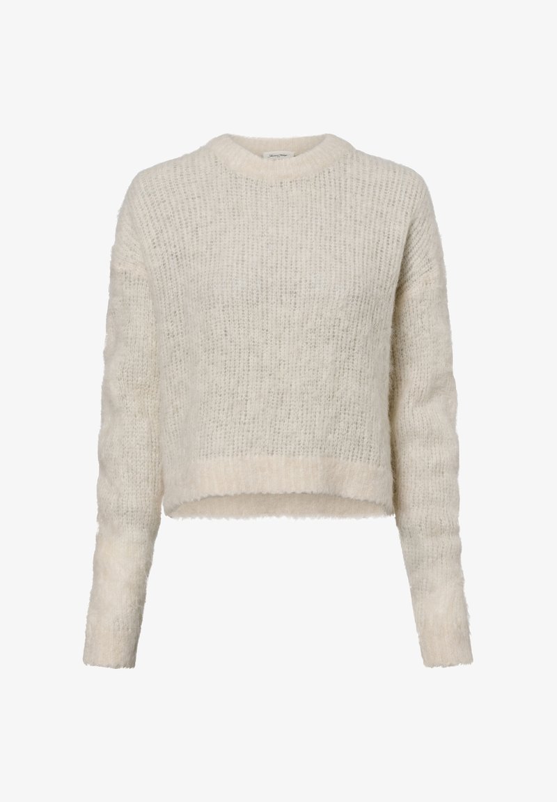 Vaaleanbeige lyhyt neulepusero, joka on valmistettu pörröisestä neuloksesta. Siinä on pitkät hihat ja pyöreä kaula-aukko, pehmeä pinta ja resorireuna.