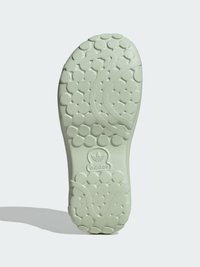 Sola de sapato de borracha verde-clara com padrão de piso circular, apresentando o logótipo da Adidas em relevo na parte traseira e um design em forma de onda no centro.