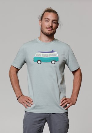 Light green t-shirt featuring a graphic of a retro van with a surfboard. Short sleeves, soft fabric, and a relaxed fit. Gray shorts worn.