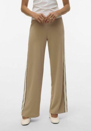 Wide-leg trousers in beige fabric, featuring side stripes in cream and black. Smooth texture with a tailored design, paired with light-colored shoes.