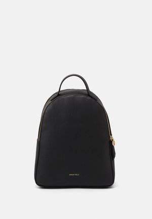 Black leather backpack with a top handle, gold zipper, and "ANNA FIELD" logo on the front center against a plain background.
