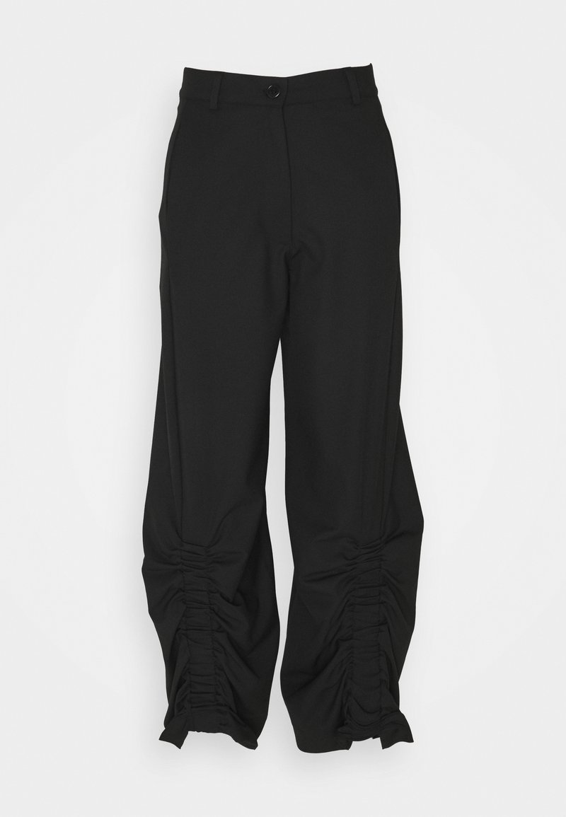 Black trousers with a ruched design at the cuffs. Made from a smooth, lightweight fabric; features a button closure and belt loops.