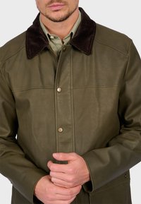 Olive green leather jacket featuring a brown corduroy collar, snap button closures, and visible stitching details on the body.