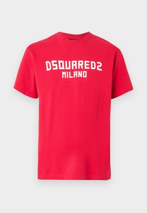 Red cotton T-shirt with short sleeves and a crew neck. Features bold white text "DSQUARED2 MILANO" across the front. Smooth texture.