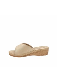 Sandali con zeppa beige, con tomaia liscia, punta aperta e design incrociato. La suola intermedia con texture in sughero offre aderenza e comfort. Suola piatta.