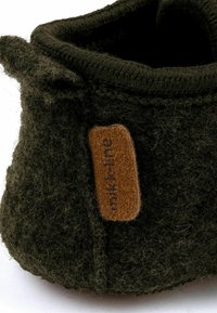 Tmavozelená filcová Papuča s textúrovaným povrchom, s hnedou tkaninovou visačkou s logom "mikk-line" a prešitým okrajom.