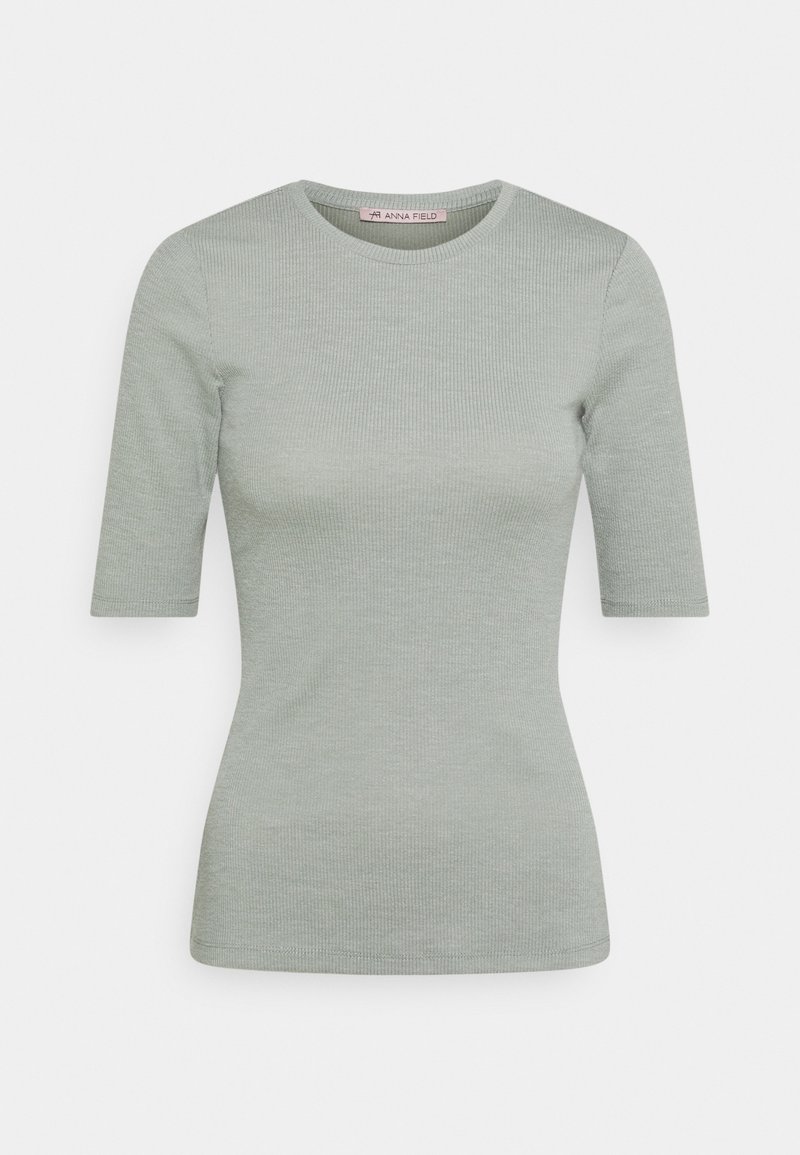 Light green ribbed t-shirt with a round neckline and short sleeves. Soft texture, fitted design, and subtle stitch detailing on the edges.