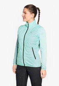 Leichte mintgrüne Jacke mit einem Reißverschluss vorne, gestepptem Muster und schwarzen Akzenten. Verfügt über lange Ärmel und seitliche Reißverschlusstaschen.