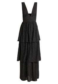 Abito nero a strati con scollatura profonda, caratterizzato da pois bianchi, spalline regolabili e una silhouette fluida. Realizzato in tessuto leggero.