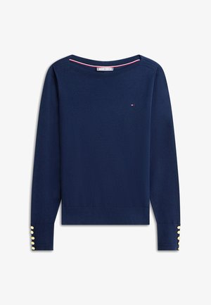 Navy blue long-sleeve sweater with boat neckline, small red-white-blue logo on chest, and gold buttons on cuffs.