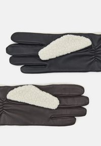 Leather gloves in black and dark brown, featuring a cream shearling accent, with gathered wrist detail and a smooth texture.