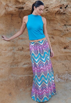 Blue sleeveless top with a high neckline paired with a long skirt featuring a multicolored zigzag pattern in pink, blue, and brown.