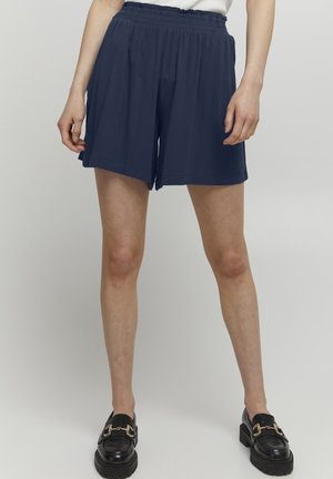 Navy blue elastic waist shorts made from soft fabric, featuring a loose fit, with side pockets and a smooth, unembellished design.