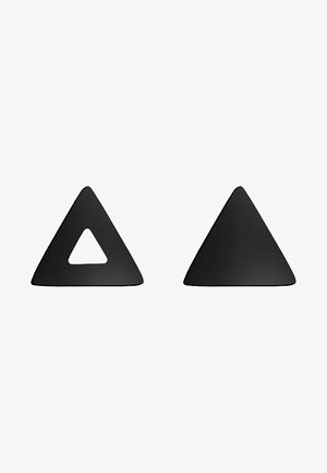 Triangles en silicone noir, l'un avec un triangle intérieur découpé. Texture lisse, finition mate, forme uniforme. Chaque triangle est solide et élégant.