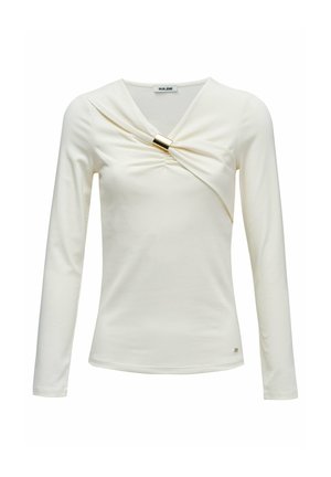 Haut crème à manches longues avec un devant froncé et un accent doré. Fabriqué en matière lisse et extensible. Design simple et ajusté.